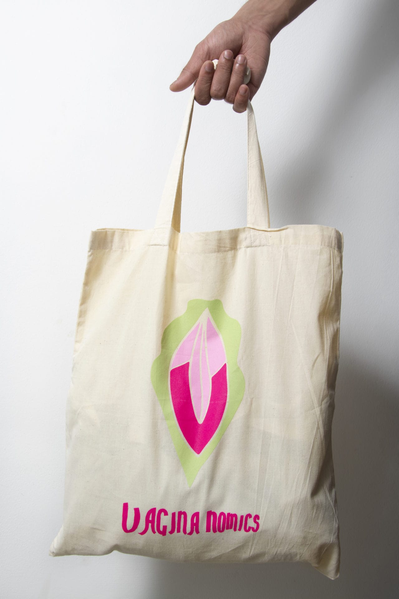 A tote bag with the print of the logo of Vagina-nomics on it.