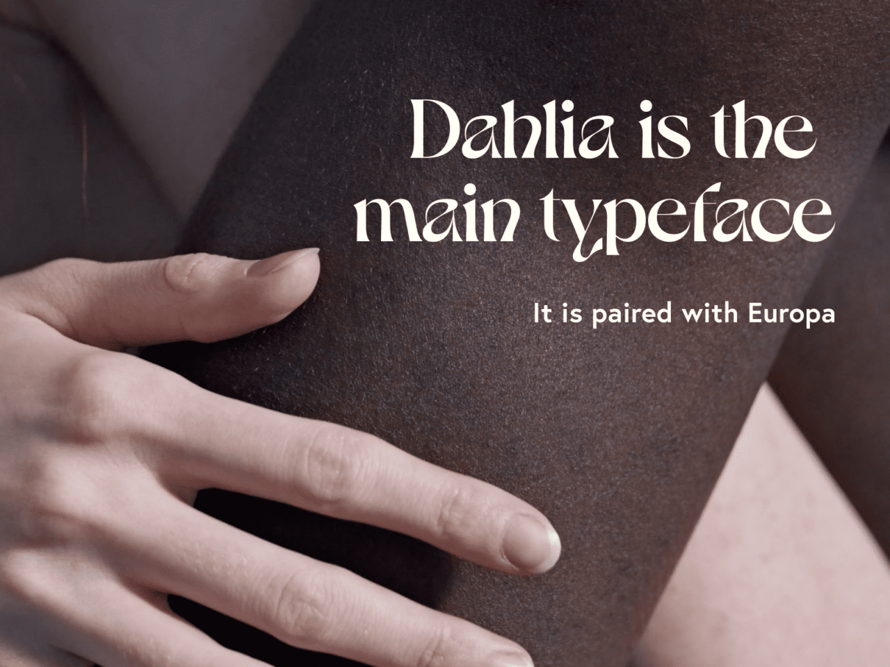 Close-up of people with different skin tones embracing. Caption reads: Dahlia is the main typeface. It is paired with Europa.