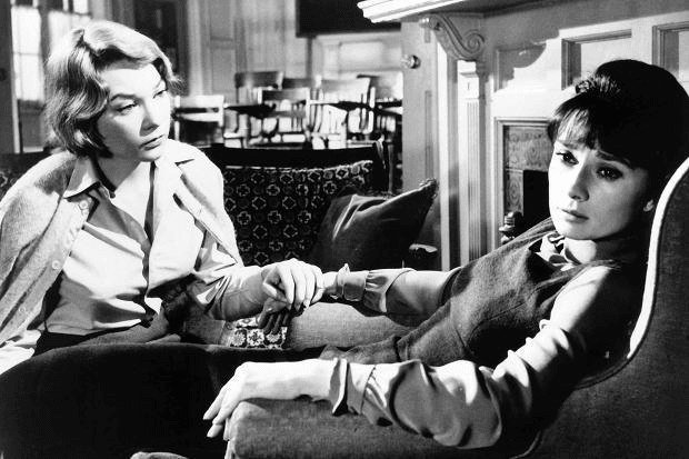Shirley Maclaine and Audrey Hepburn in The Children's Hour; they two leads sit together with faces stricken by concern
