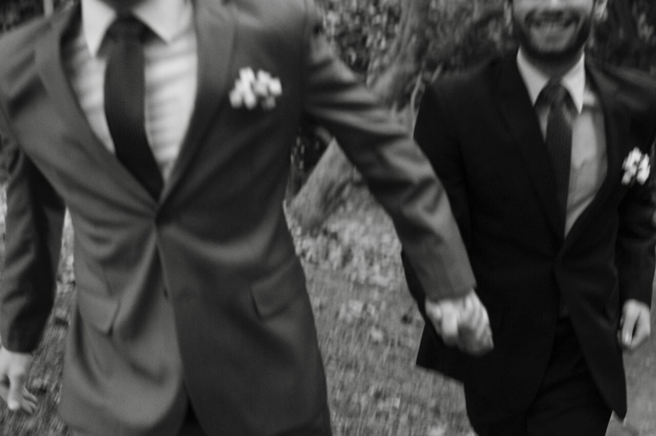 black and white photo of two men in suits after getting marries