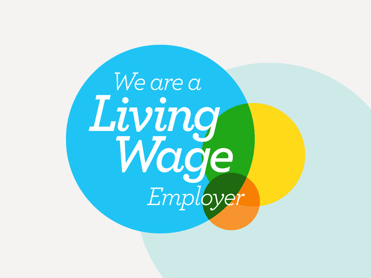 Living Wage Employer Logo showing three intersecting circles, a small orange one on the bottom right, a medium yellow one on the right and a big blue one on the top left with text inside reading 'We are a Licing Wage Employer'